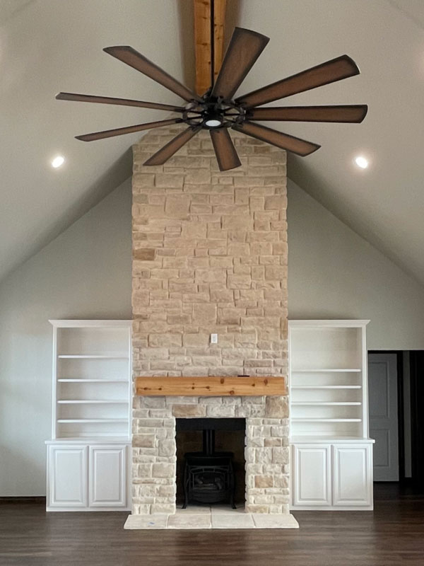 Custom features in a new Oklahoma home, including a fancy fireplace and built-in shelves